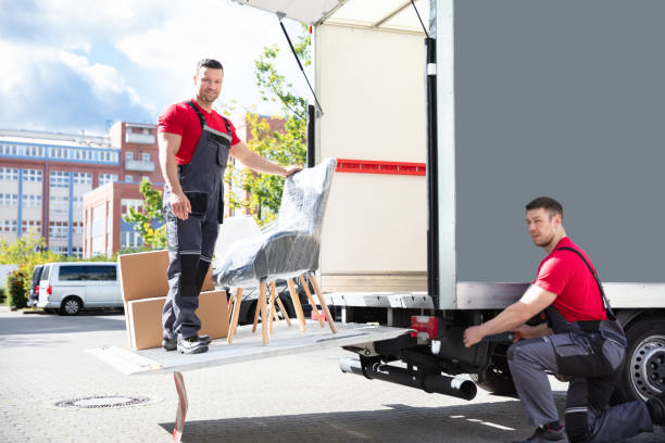 istock Male Movers Loading Cardboard Boxes In Truck On Street 1325529817