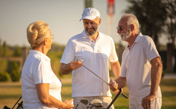 istock Senior friends on golf court talking. 1325530062