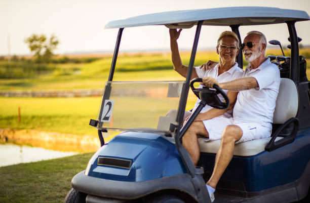 istock Senior golf's couple in golf car. 1325530159