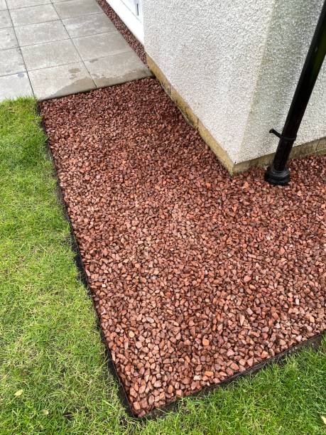 istock Red stone garden path at back of house 1325530263