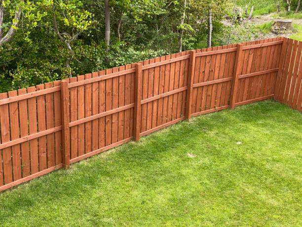 Wooden garden fence coated with medium oak colour paint Wooden garden fence coated with medium oak colour paint UK partition stock pictures, royalty-free photos & images