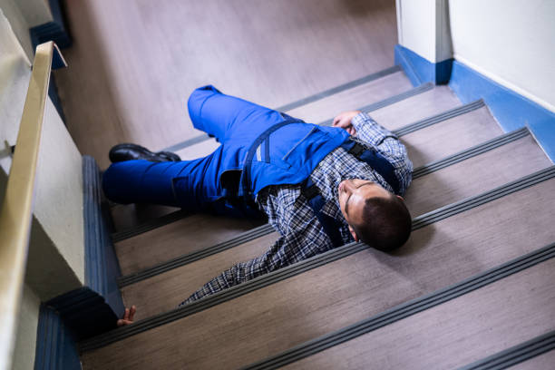 istock Worker Man Lying On Staircase After Slip 1325531115