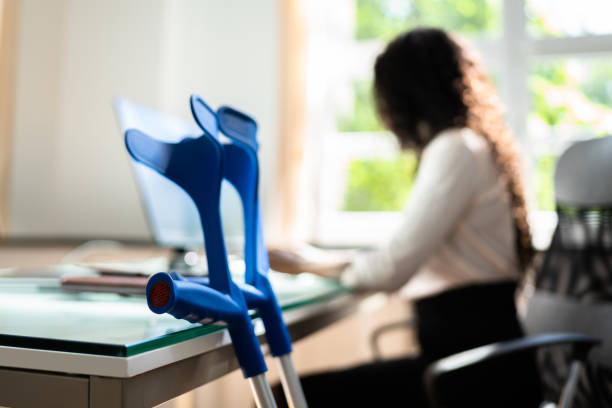 istock Handicapped Worker With Crutches At Workplace 1325531345