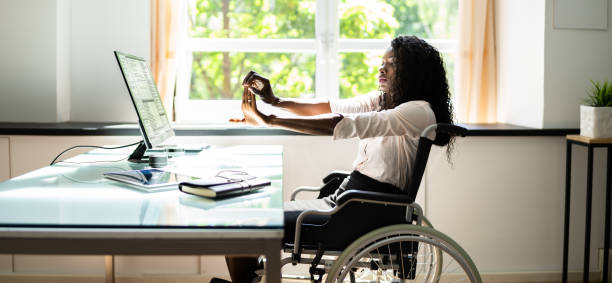 istock Disabled African Woman Stretching At Desk Working 1325531354