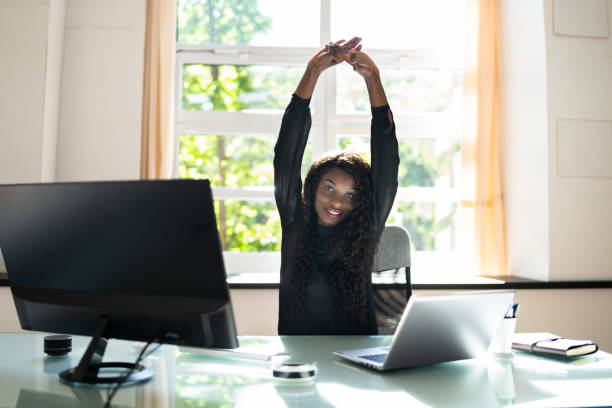istock African Woman Stretching Exercise At Desk Working 1325531594
