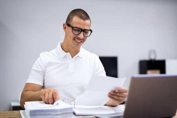 istock Happy Young Man Doing Taxes 1325532547