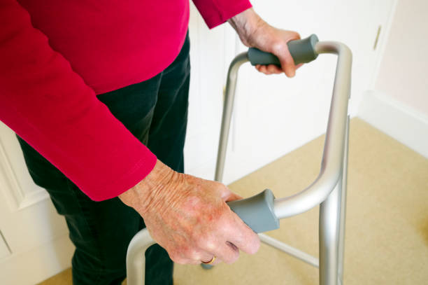 istock Old person with walking frame inside house 1325532570