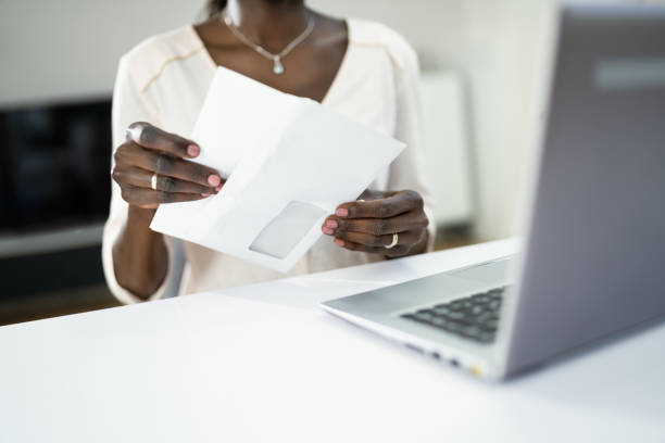 istock African Woman Holding Mail 1325532731