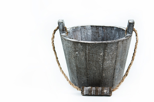 Gray wooden bucket isolated on white background stock photo.