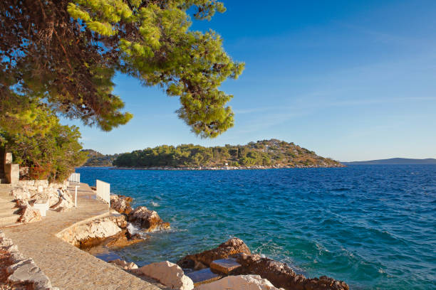 Walking path along the seashore at croatian town Tribunj