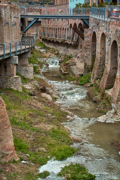 istock An old river channel with a small mountain river. 1325537172