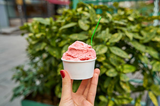istock Ice cream in a paper cup. Sweets and weekend walks 1325537232