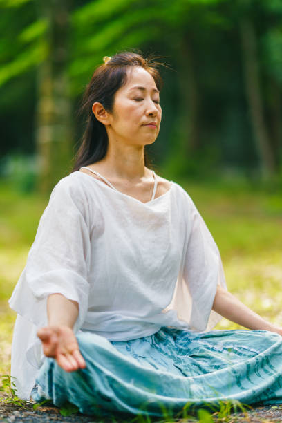 istock Woman practicing meditation and yoga in nature 1325537444