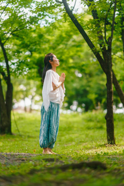 istock Woman practicing meditation and yoga in nature 1325538490