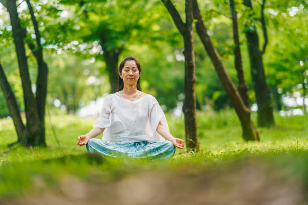 istock Woman practicing meditation and yoga in nature 1325539314