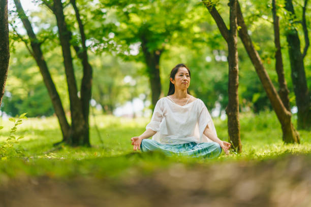 istock Woman practicing meditation and yoga in nature 1325539357