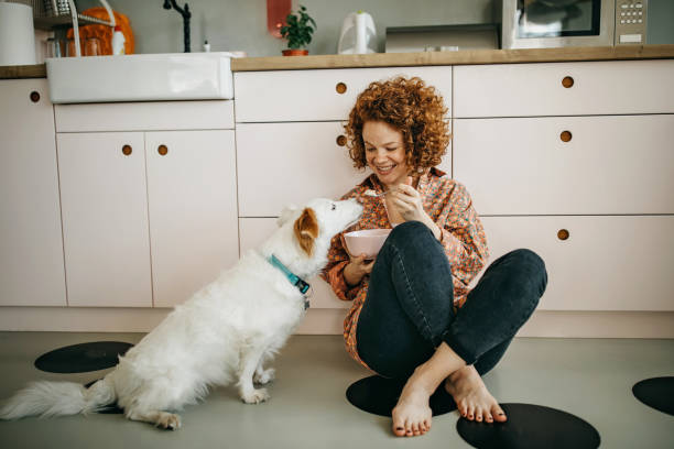 istock Beautiful redhead eating breakfast on the kitchen floor 1325539646