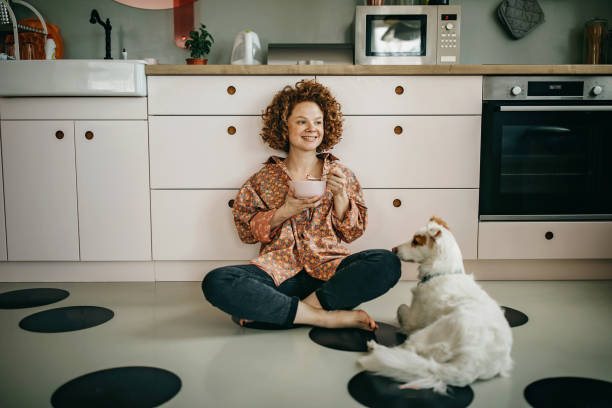 istock Beautiful redhead eating breakfast on the kitchen floor 1325539667