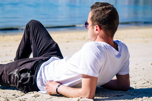 istock relaxed man lying on the beach sand 1325540781
