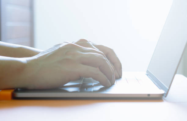 istock White Light - Anonymous professional business man or worker typing keyboard on notebook or laptop at home to communicate with employee or worker or customer via online internet network on computer 1325547119