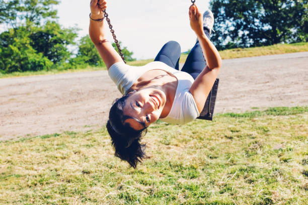istock Woman swinging high and turning back 1325547524