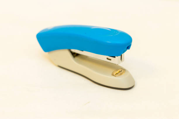 istock Blue and grey stapler office supplies close up isolated on the white 1325548218