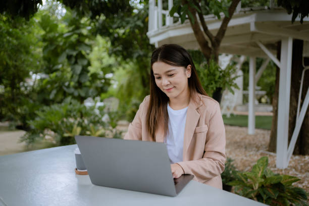 istock Asian woman working laptop at cafe. 1325549042