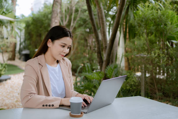 istock Asian woman working laptop at cafe. 1325549059