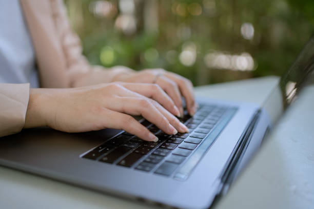 istock Asian woman working laptop at cafe. 1325549095