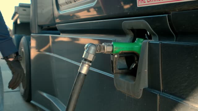 Close up shot of Filling up a truck with fuel at truck gas station,