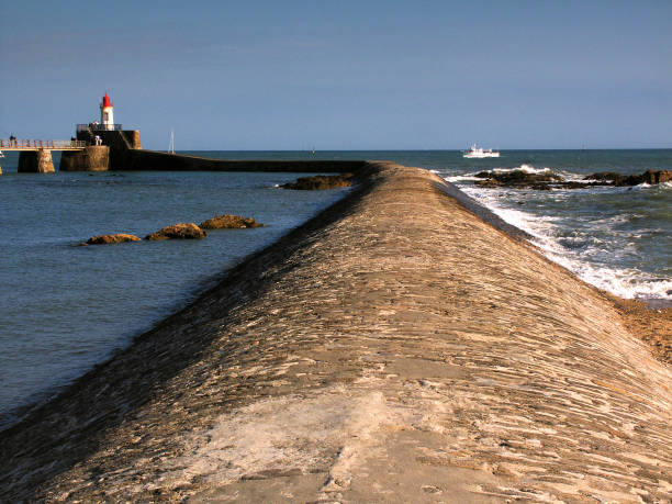 June 27th. 2021. This is Les Sables-d'Olonne a seaside holiday resort town in Western France, on the Atlantic Ocean. It is known as the starting point of the Vendee Globe round the world yacht rave. This is a view of the harbouring fort. se trata de les sables-d'olonne, una ciudad balnearia en el oeste de francia, en el océano atlántico. es conocido como el punto de partida de la vendée globe alrededor del mundo yate rave. esta es una vista del puerto con barcos y turistas que se despla