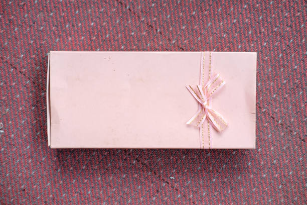 white gift box with red ribbon and bow
