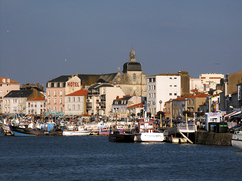 June 27th. 2021. This is Les Sables-d'Olonne a seaside holiday resort town in Western France, on the Atlantic Ocean. It is known as the starting point of the Vendee Globe round the world yacht rave. This is a view of the harbour with boats and tourists walking around enjoying the sunshine.