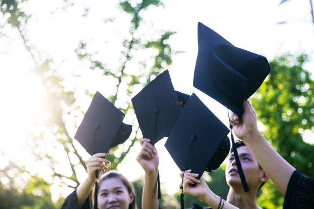 istock holding a shot of graduation cap 1325555921