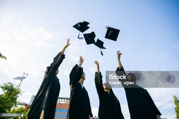 College Students Celebrating Their Graduation Stock Photo - Download Image Now - Mortarboard, Throwing, Graduation