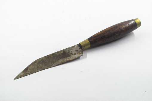rusty and a worn traditional kitchen knife with a wooden handle on white background