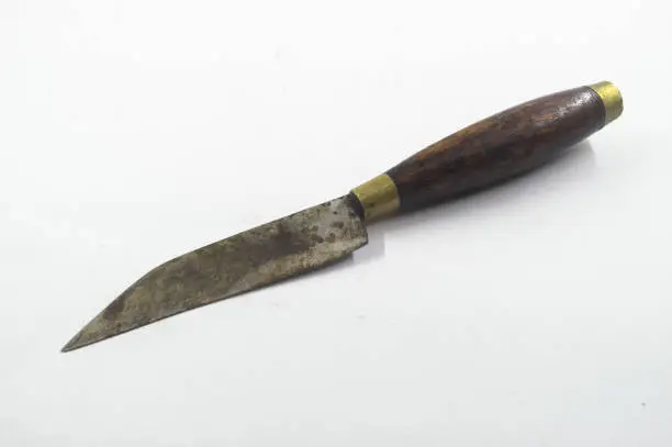 Photo of rusty and worn traditional kitchen knife with wooden handle