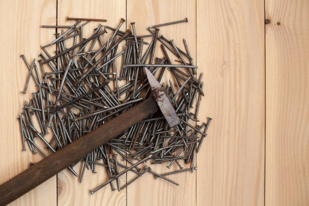 istock Hammer and nails on rustic wooden background with space for text. 1325564206