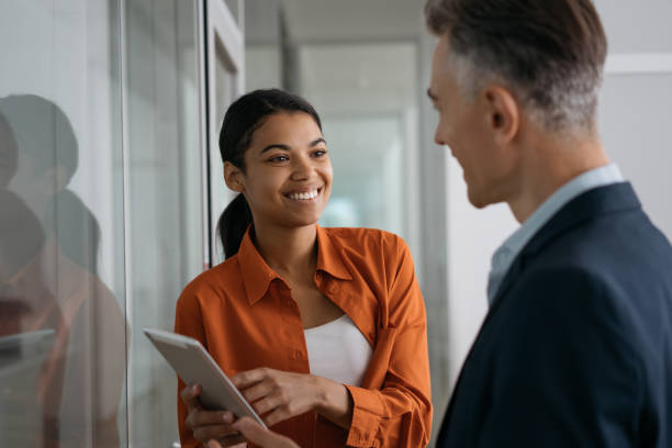 istock Business people meeting, talking, working together in modern office. Recruiter using digital tablet listening to candidate at job interview. Recruitment process concept 1325565897