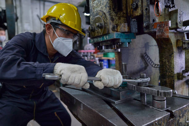 istock Asian engineer repair or install nut on machine with giant wrenc 1325566664