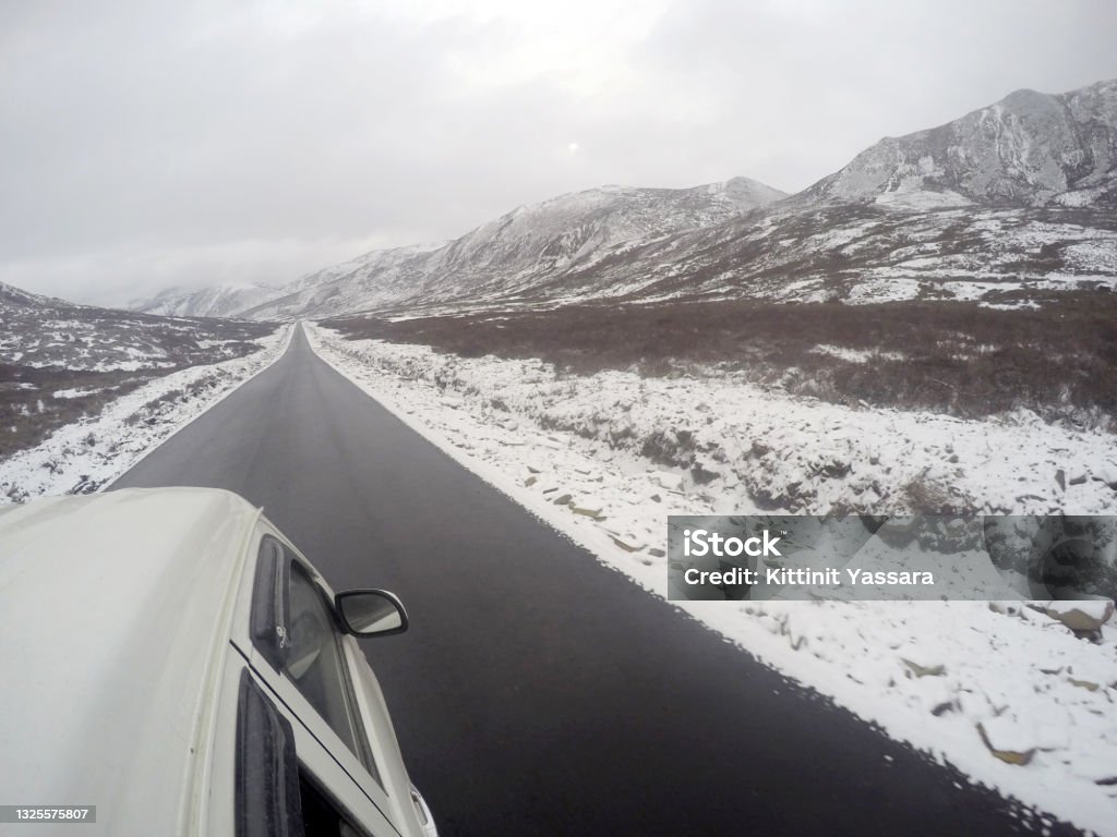 Nature scene of Landscape Road on the snow mountain from Xiangcheng to Yading National Reserve. It Beautiful road with snow on the way. Travel backpack outdoor road trip Adventure Stock Photo