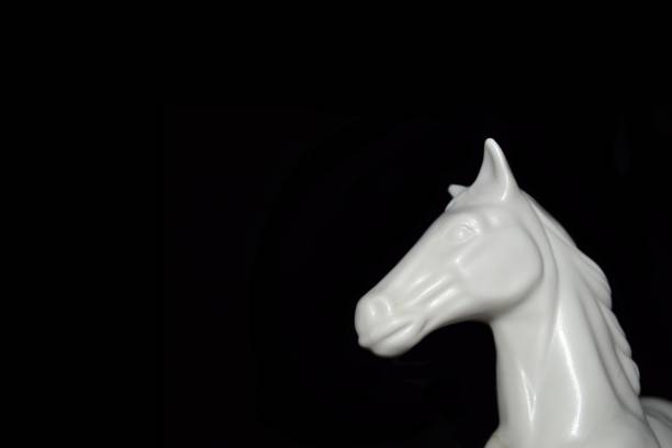 istock White Horse sculture black background 1325578424