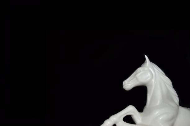 istock White Horse sculture black background 1325578427