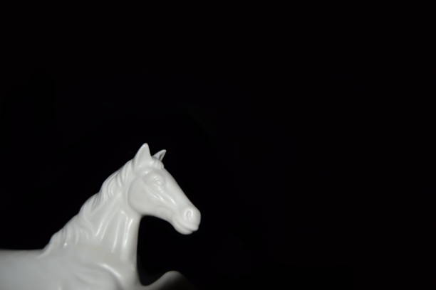 istock White Horse sculture black background 1325578446
