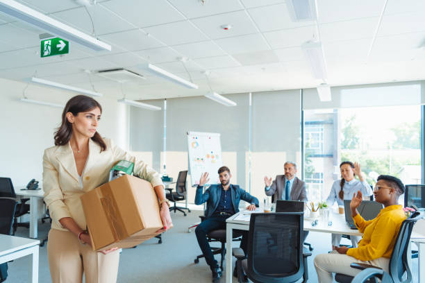 shot of an unhappy businesswoman holding her box of belongings after getting fired from her job - finishing employment issues occupation downsizing imagens e fotografias de stock