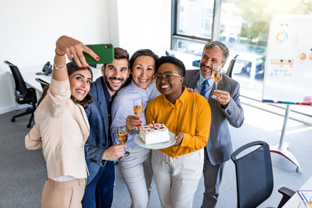 istock Happy friends talking a selfie in the office 1325584302
