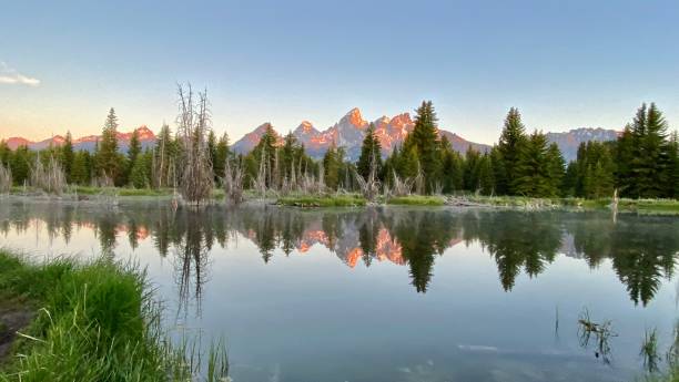istock the grand teton mountain range reflected on the mighty snake river at dawn 1325585938