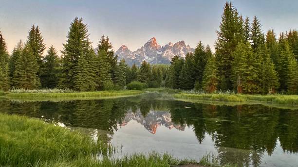 istock the grand teton mountain range reflected on the mighty snake river at dawn 1325585944