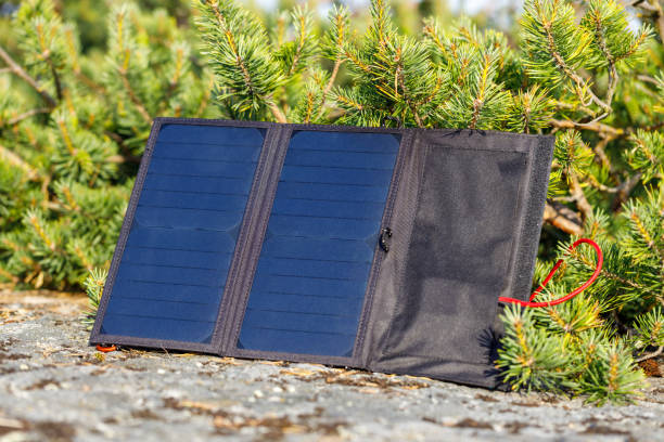 Outdoor travel solar panel charging. stock photo