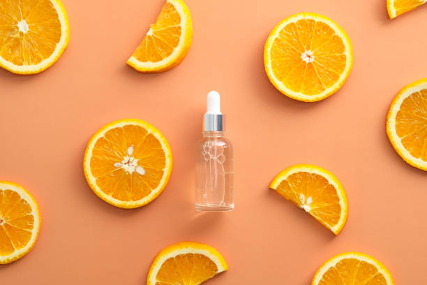 istock Clean dropper bottle Vitamin C extract and sliced orange top view. 1325588167